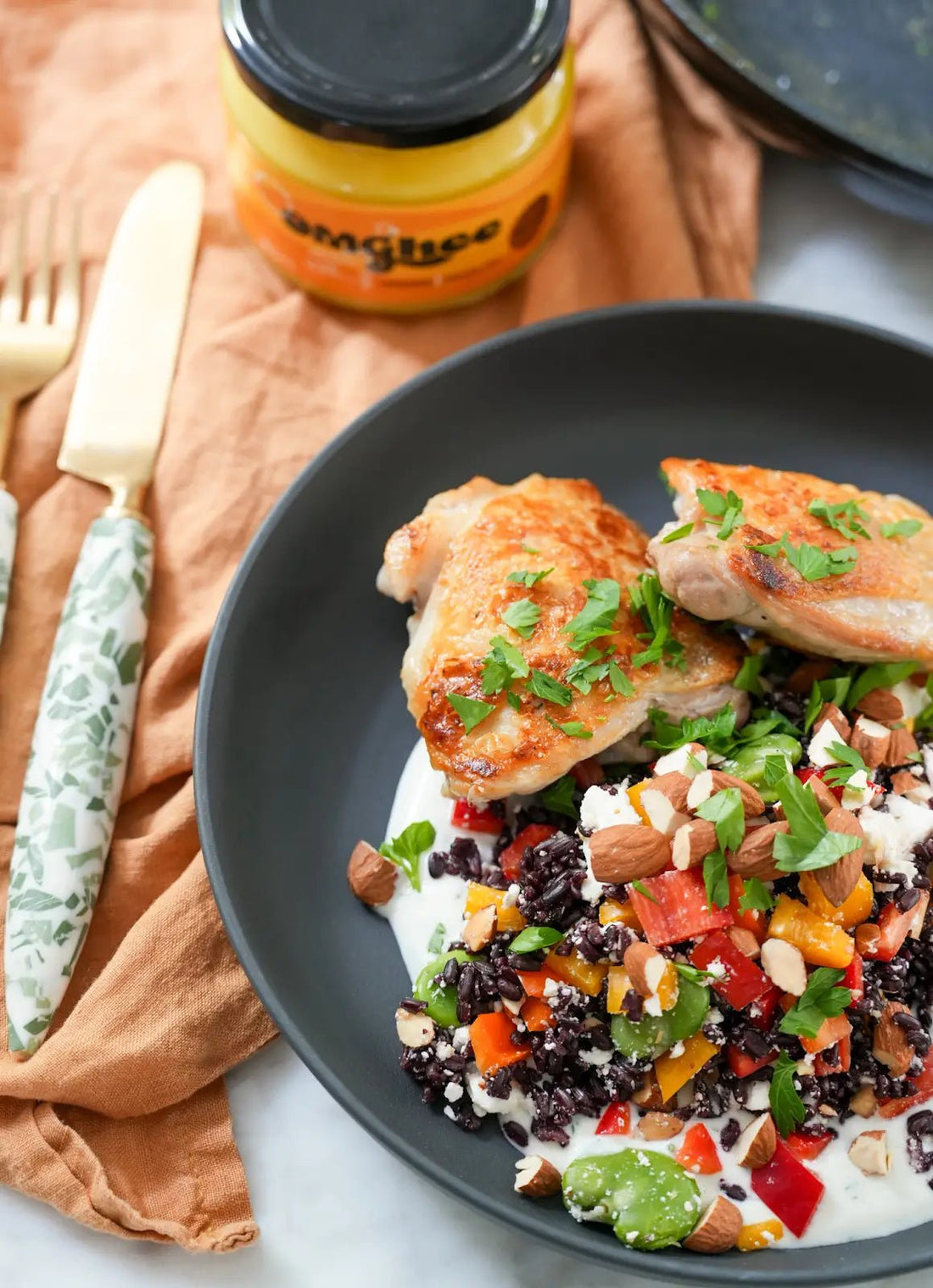 Crispy skinned chicken on plate with a rainbow salad