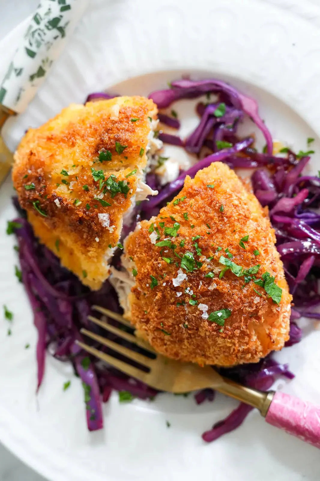 Herby Chicken stuffed with ghee sitting on cabbage.