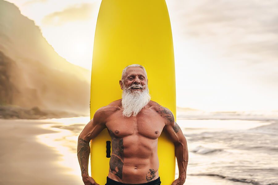 Healthy man with yellow surfboard Health Benefits of Ghee. Our Top 10. - OMGhee