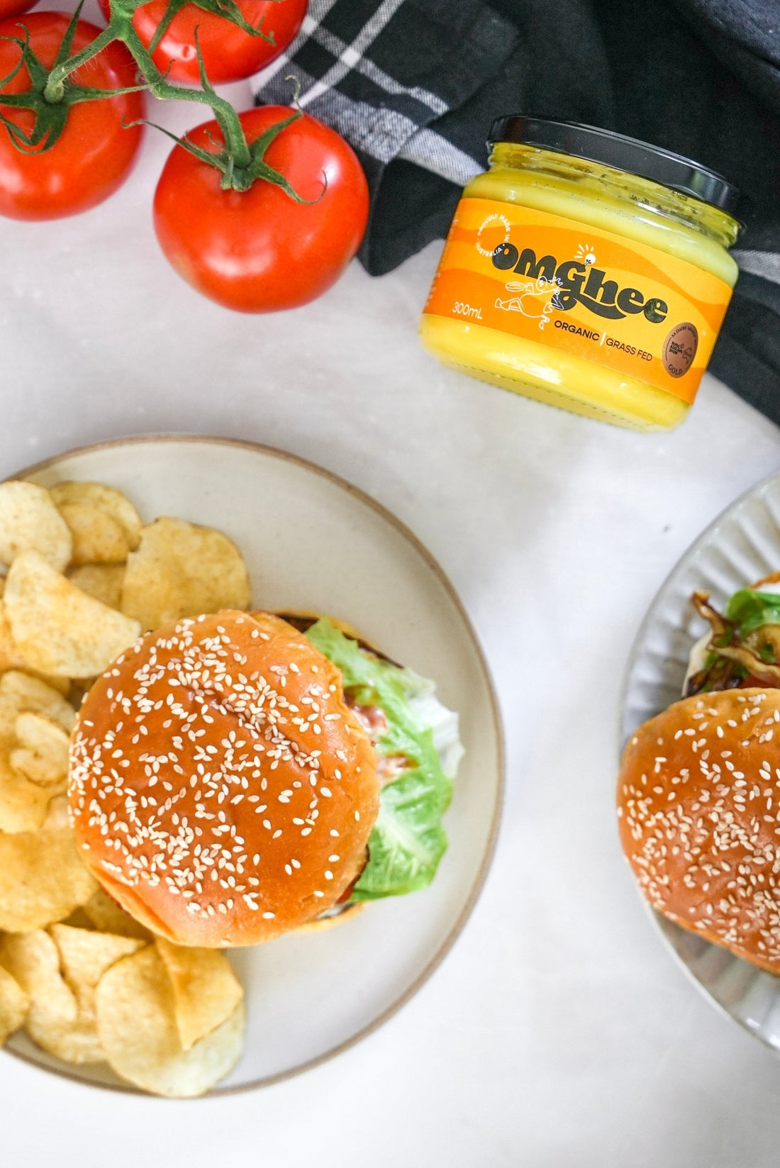 hamburger with blue teatowl, tomatoes and jar of omghee ghee