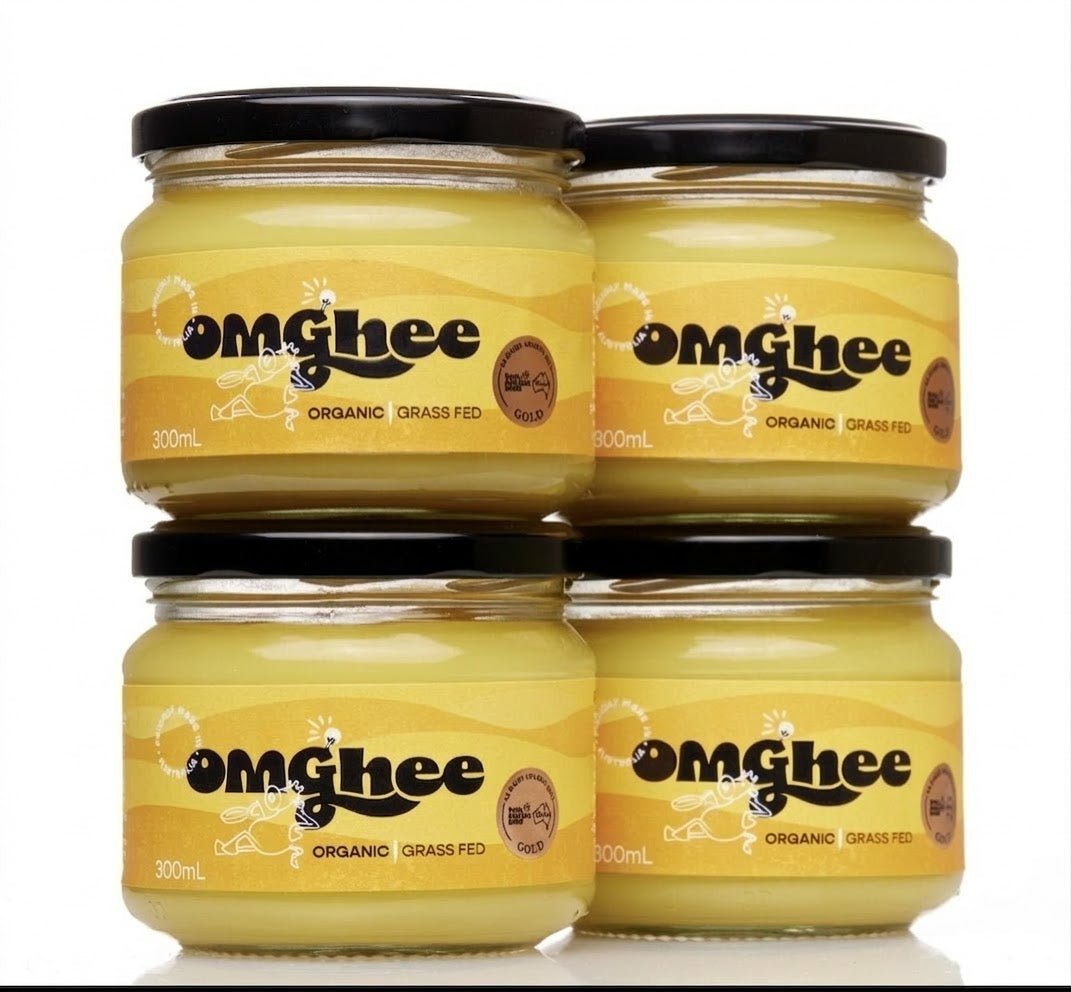 Four jars of OMGhee certified organic grass-fed ghee on a white background