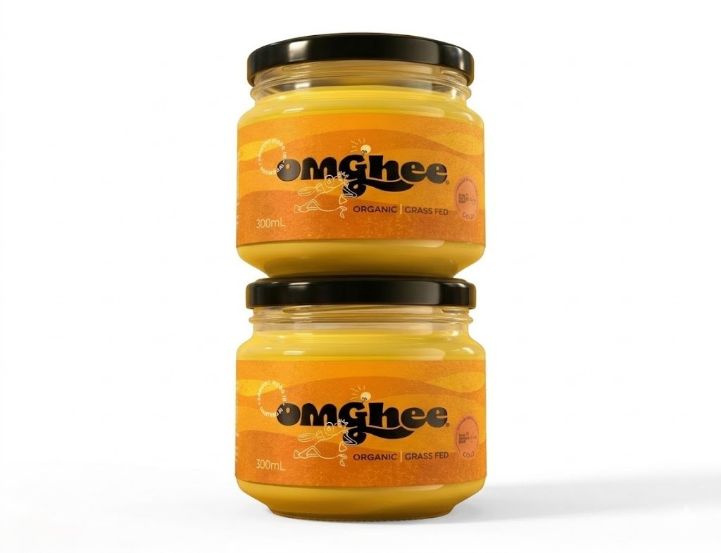 Two jars of omGhee organic grass-fed ghee on a white background